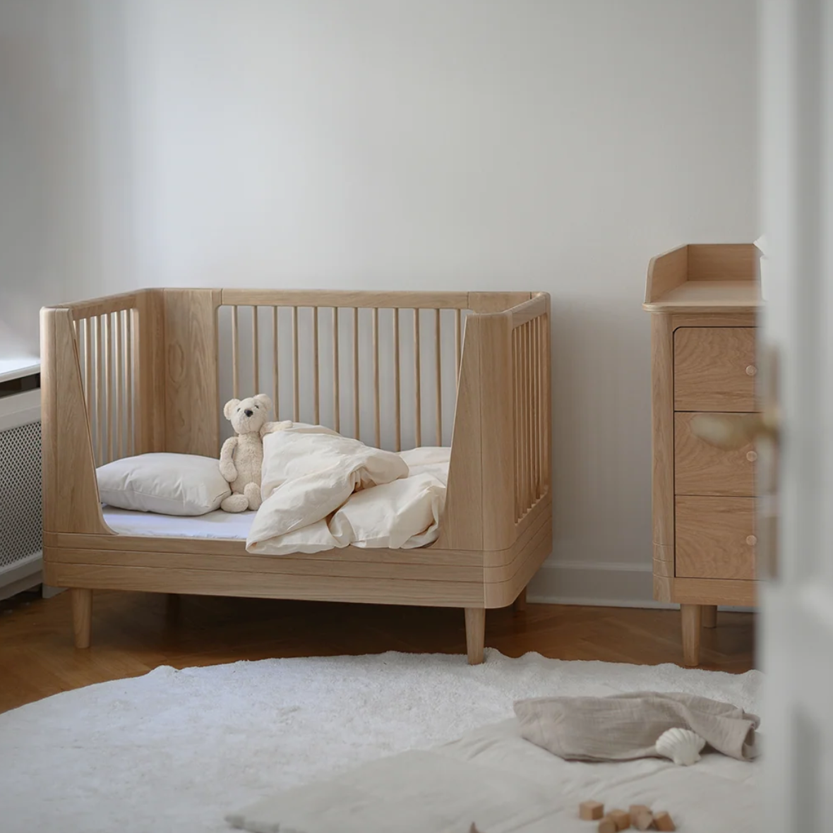 We Are Bitte Nature 2.0 Babybett aus Eiche mit abgerundeten Seitenteilen und natürlicher Holzmaserung